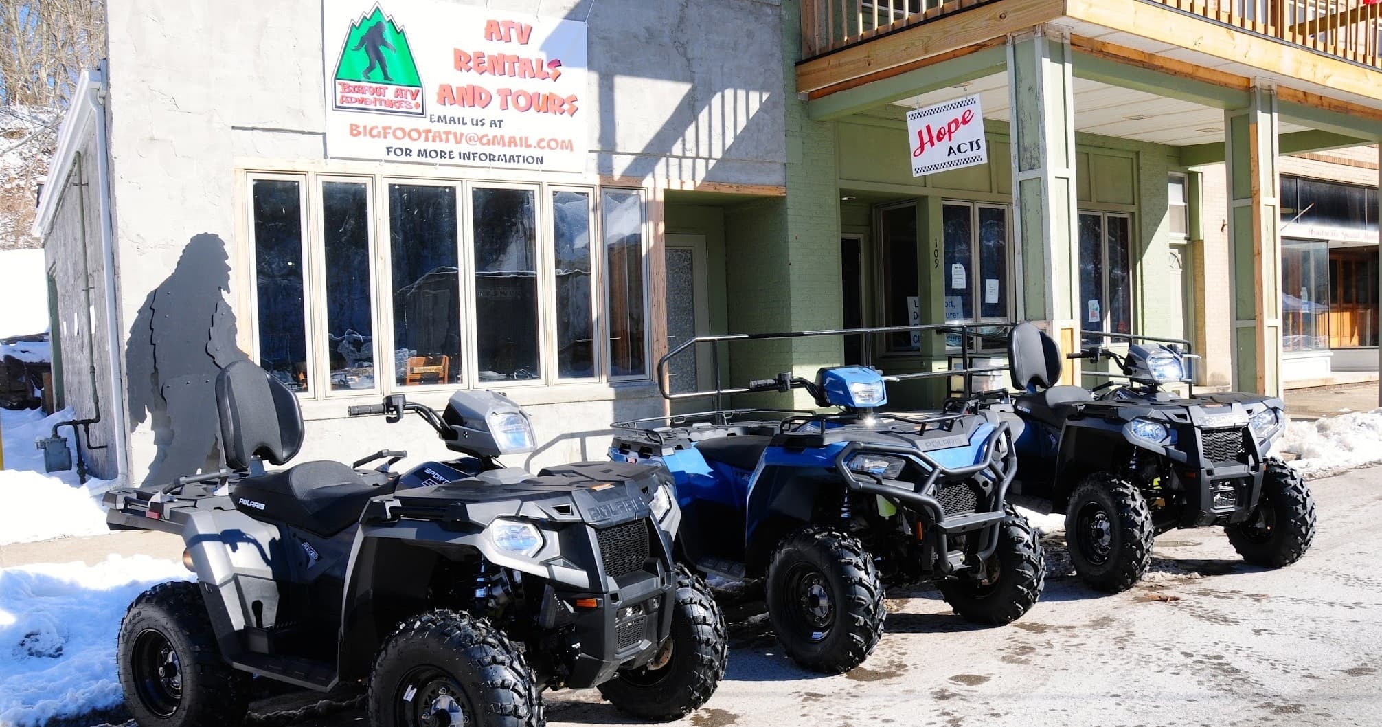 ATV rentals parked outside mountain lodge in snowy winter
