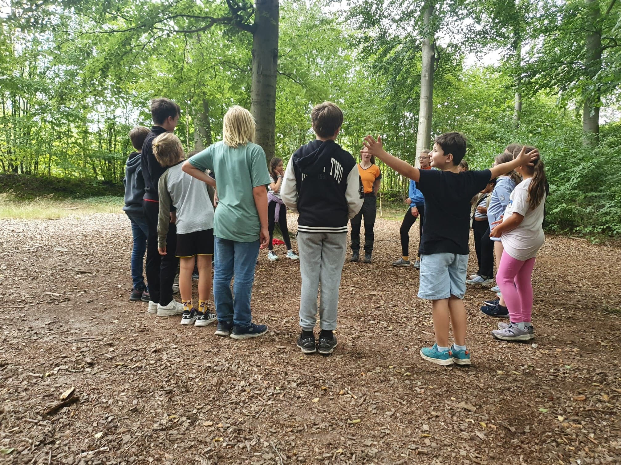 Group briefing and team building at forest obstacle course base