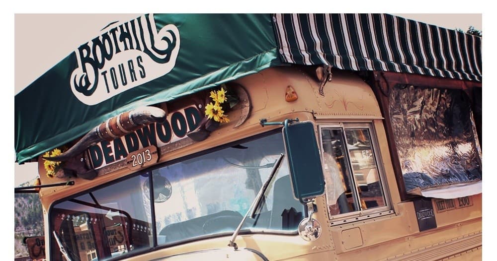 Historic Deadwood trolley tour under green Boothill canopy