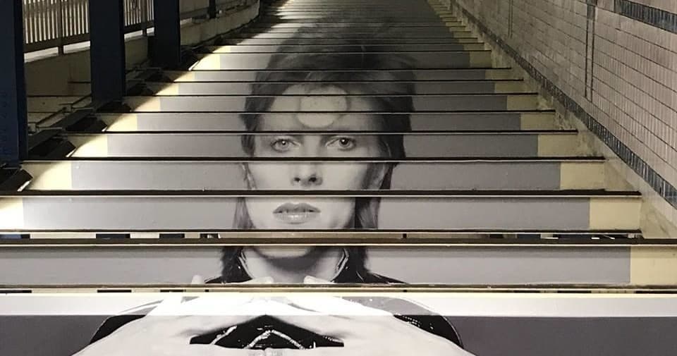 Subway stair mural portrait along urban stairway in NYC