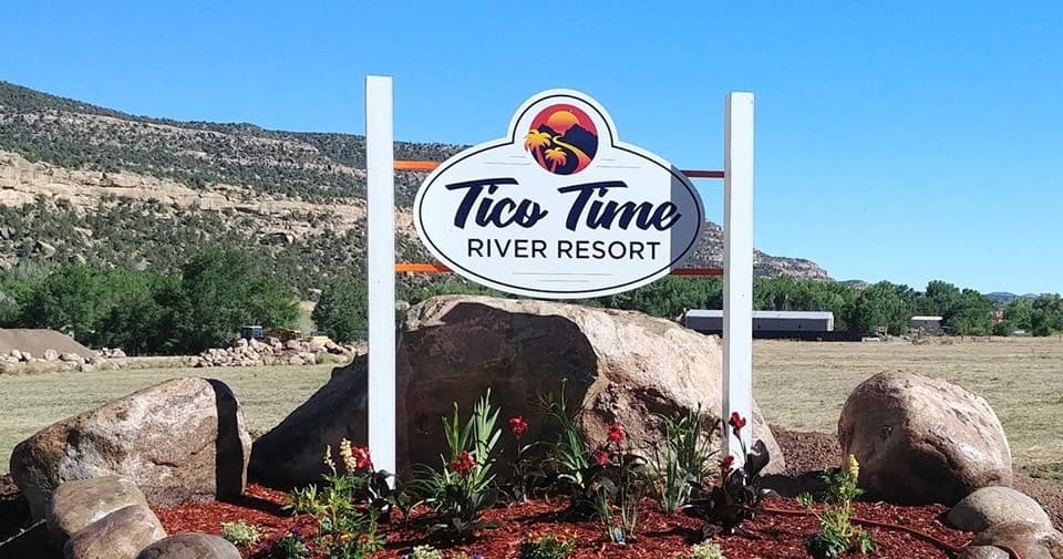 Tico Time River Resort sign at riverside RV park entrance