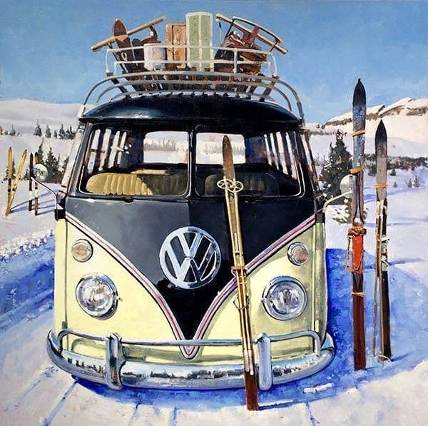 Vintage VW camper with skis parked in snowy alpine resort
