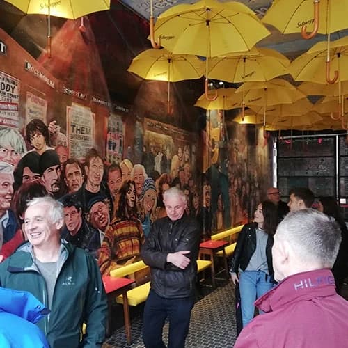 Guests amid yellow umbrella art installation in Belfast bar