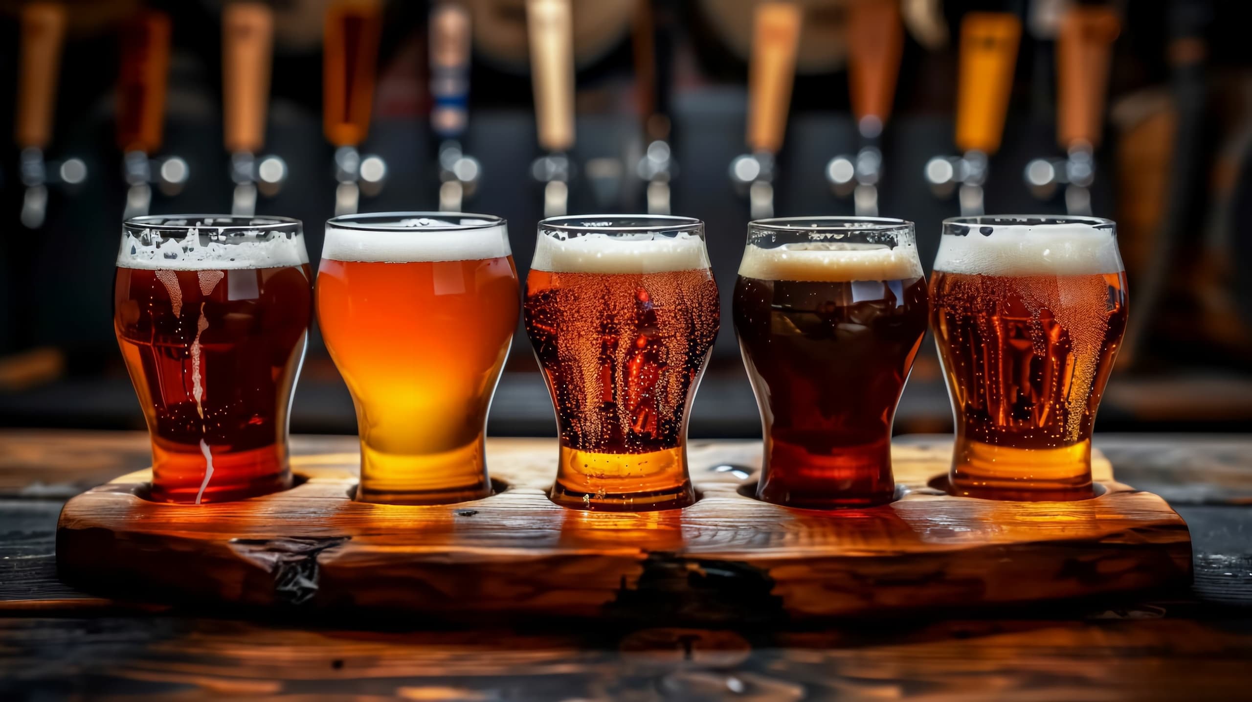 Assorted craft beer flight on wooden paddle in taproom