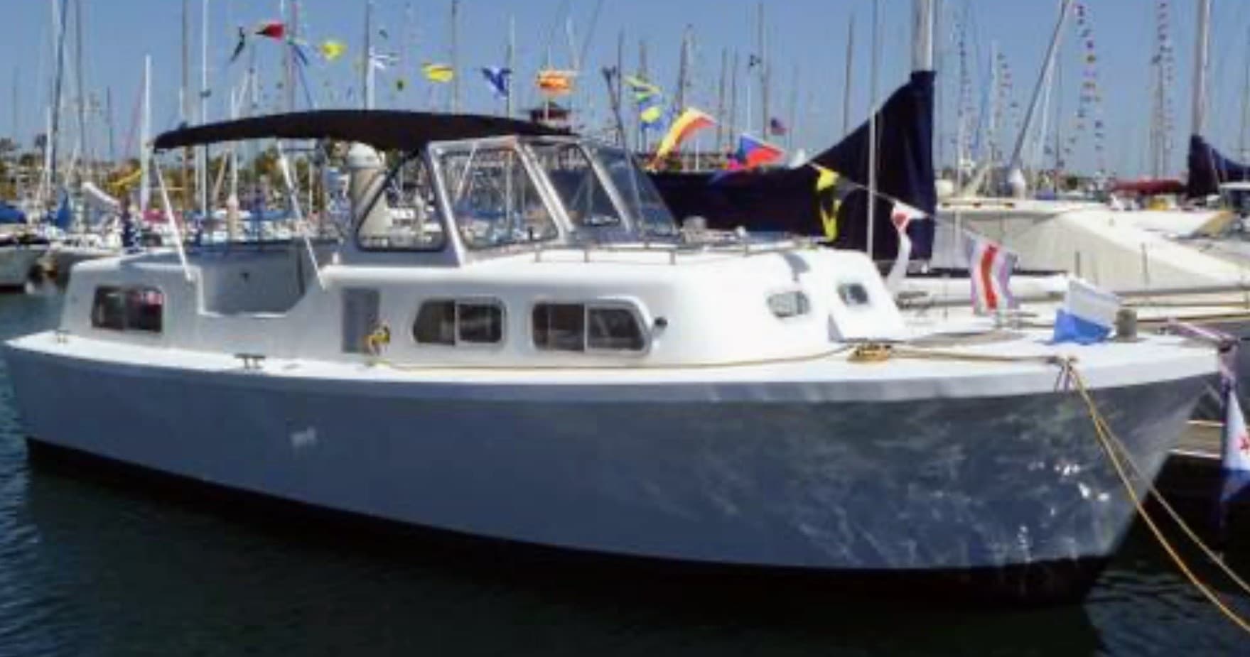 Motorboat docked at busy marina, leisure cruising vessel view