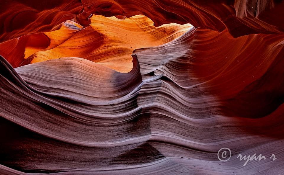 Curving Antelope Canyon sandstone walls glowing with warm light