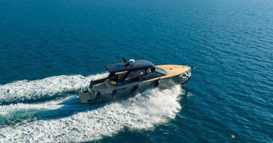 Motorboat cruising on open ocean creating dramatic wake