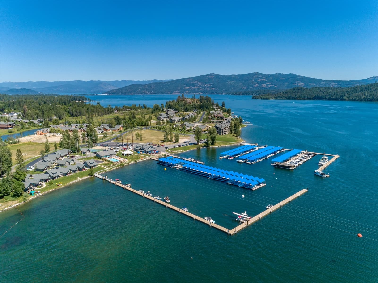 Aerial view of marina and lakefront docks on clear summer day