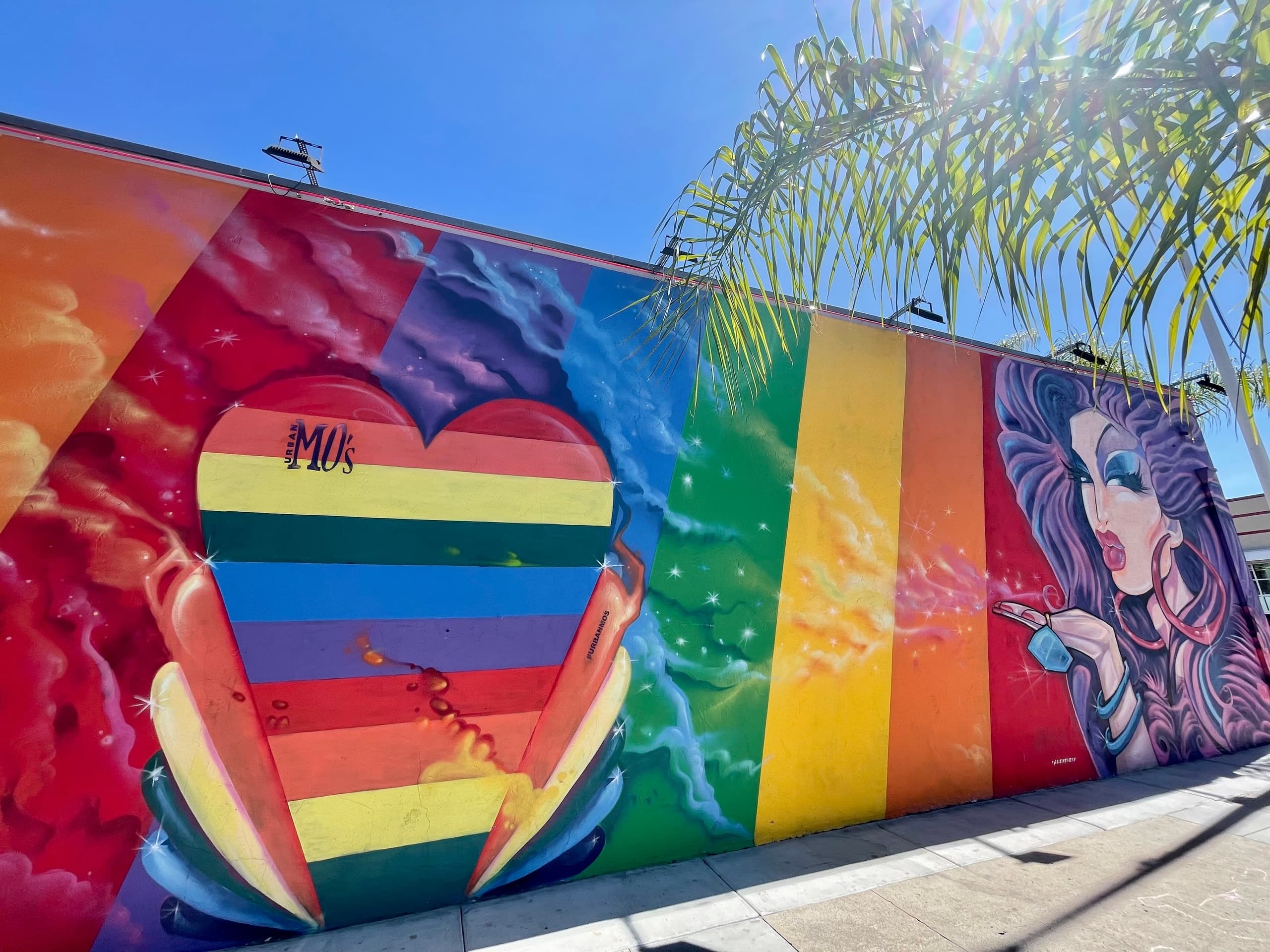 Rainbow heart street mural on urban wall, colorful outdoor art