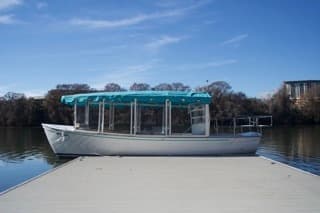 Glass-roof tour boat moored at Austin lakefront dock