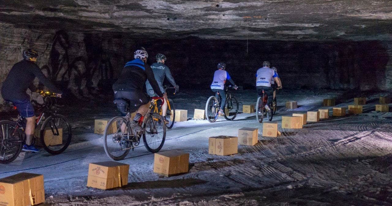 Group mountain biking along underground salt mine trail