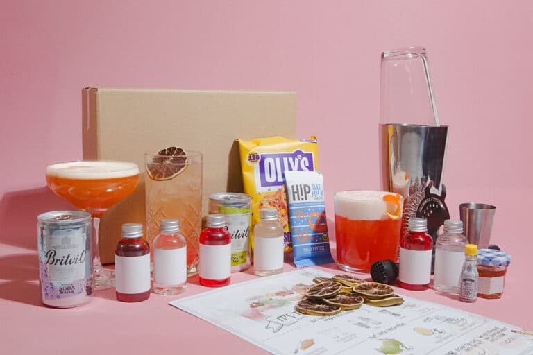 Cocktail kit and mixers on studio table for home mixology