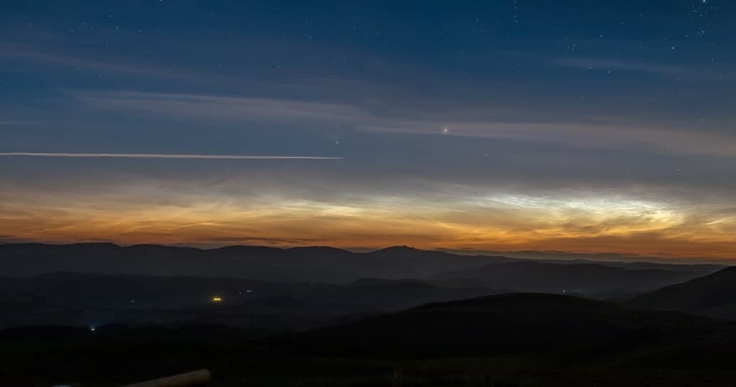 Dramatic sunset and layered hills skyline over Welsh countryside