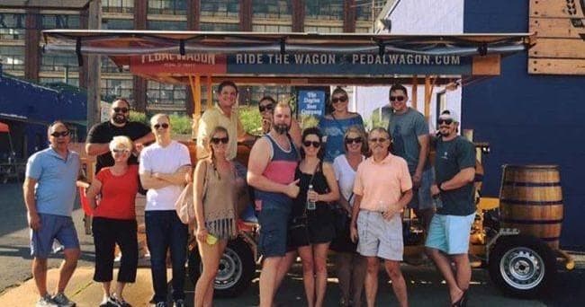 Large group tour boarding pedal wagon for urban sightseeing