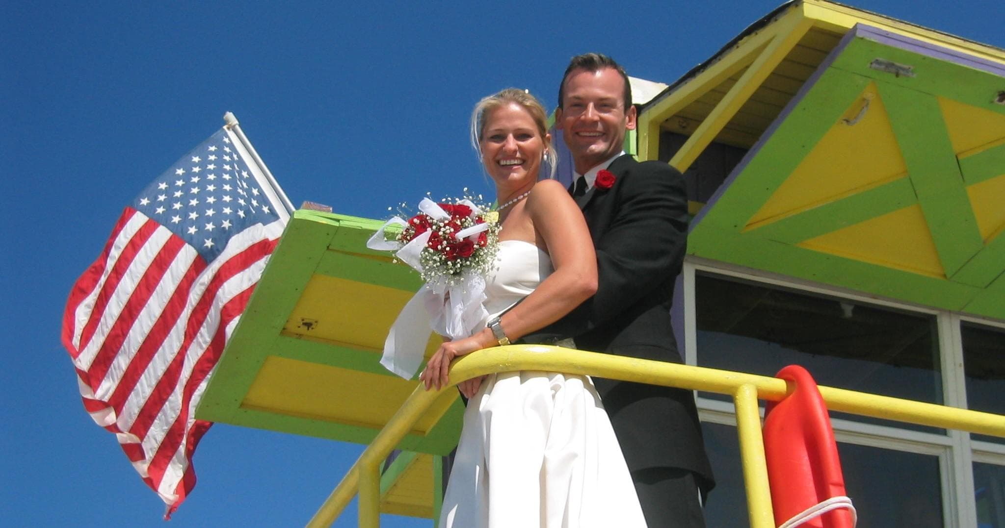 Large yacht cruising crystal Caribbean waters with island backdrop