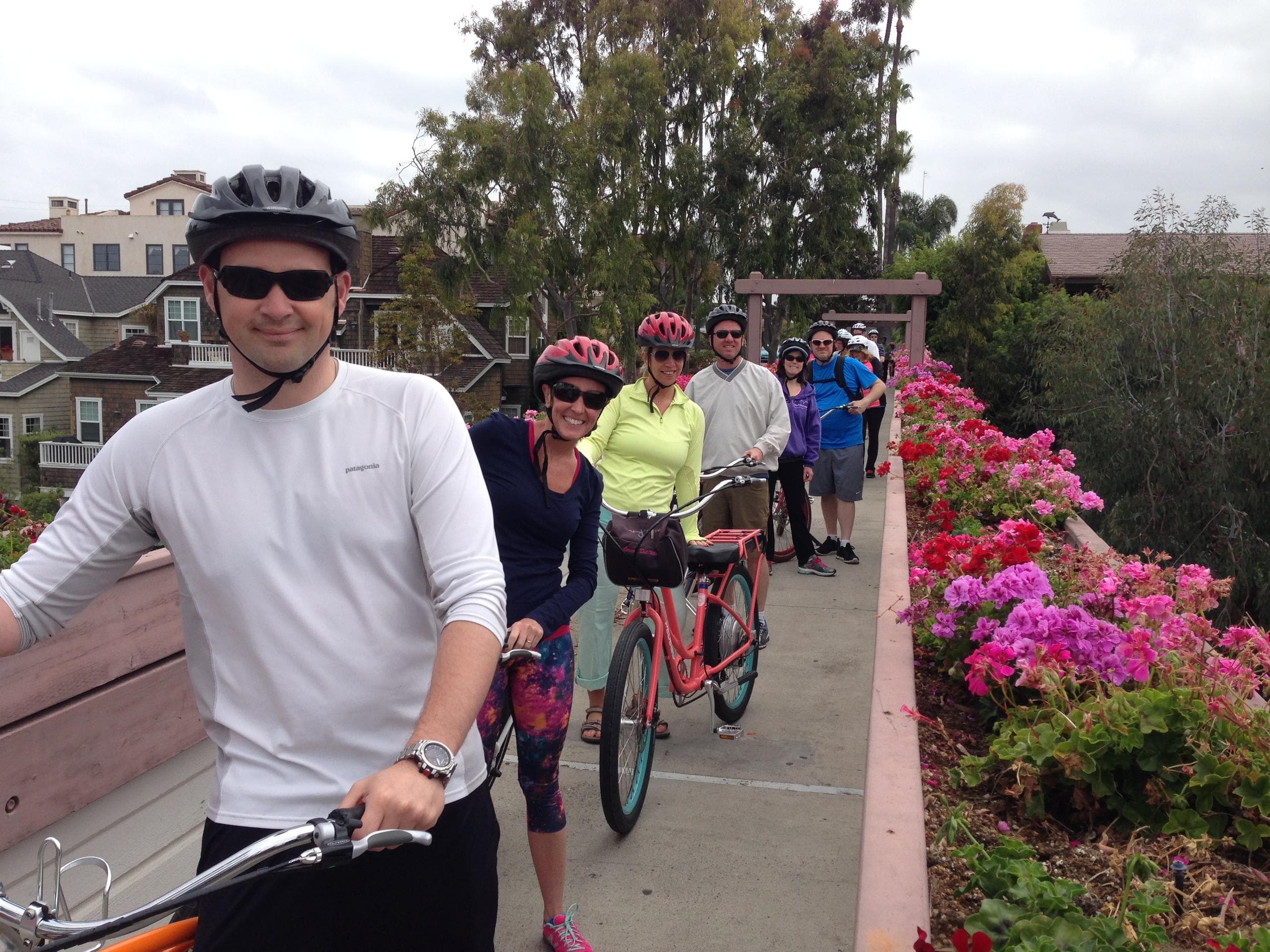 Guided e-bike tour group cycling along coastal promenade