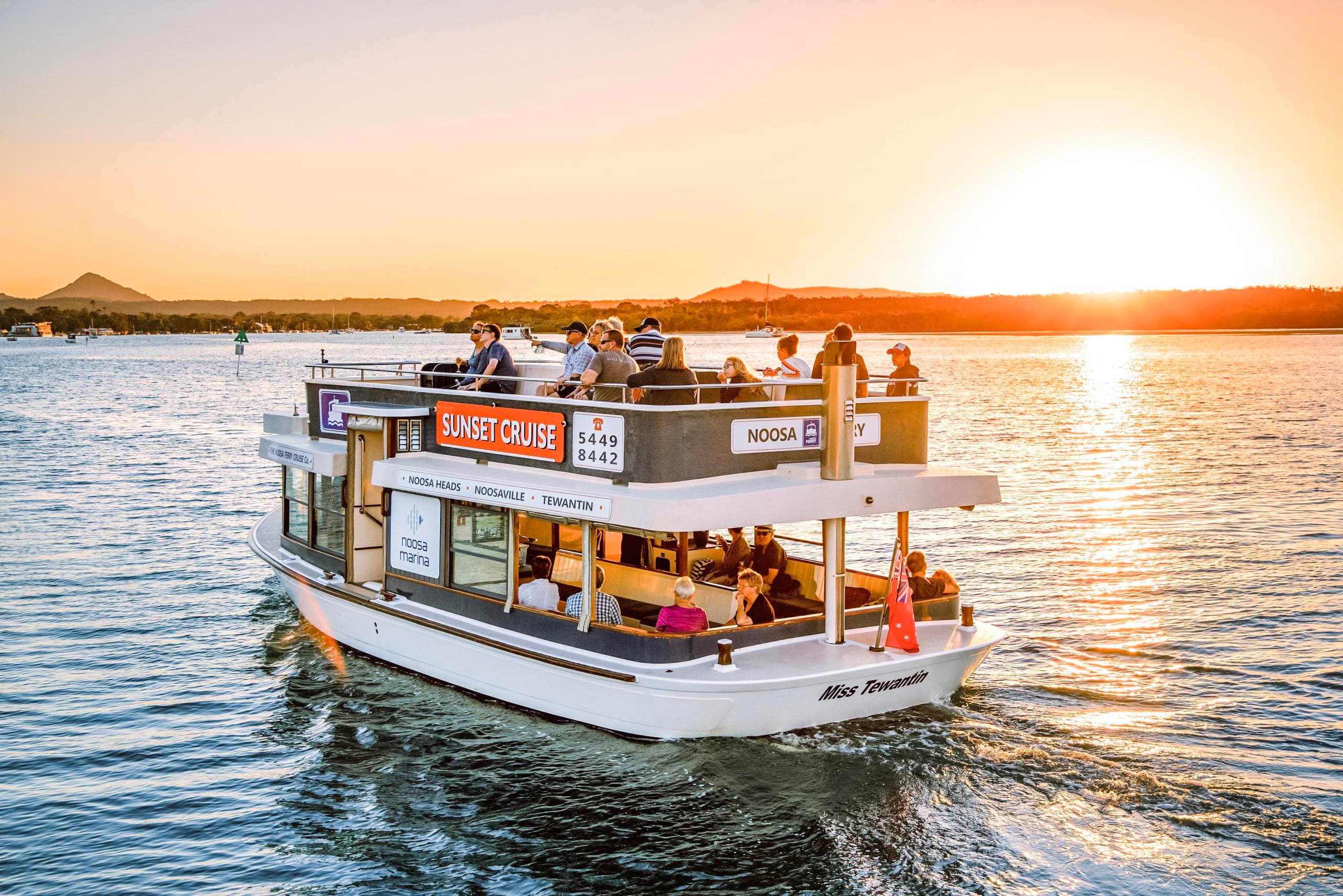 Passenger ferry on Noosa River at golden hour sightseeing