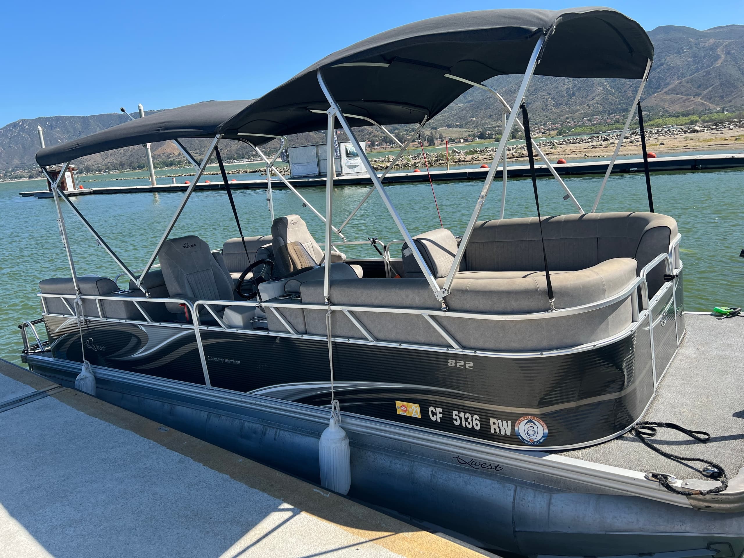Pontoon boat docked on a mountain lake for scenic family cruising