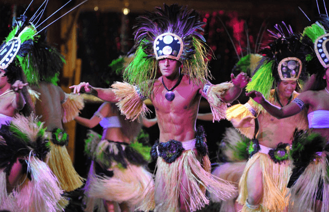 Polynesian dancers performing colorful hula near tour vehicle