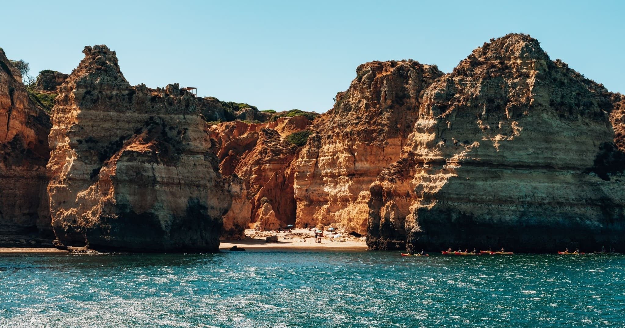 Coastal sea cliffs with turquoise water on a boat excursion