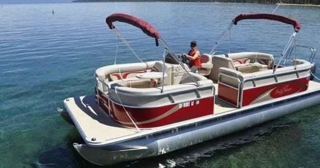 Aerial view of speedboat slicing blue lake waters near Tahoe coast