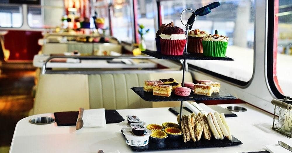 Afternoon tea spread inside vintage bus dining carriage
