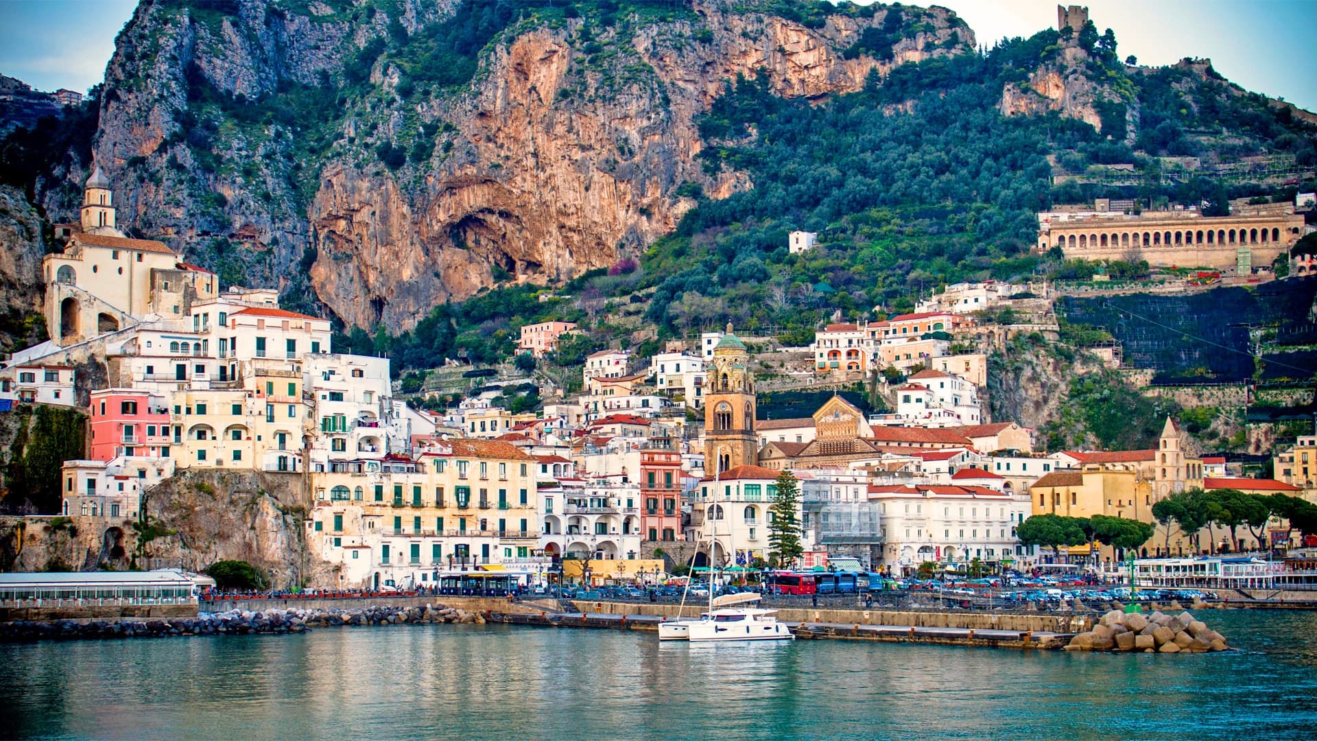 Amalfi Coast village along rocky shoreline with harbor view