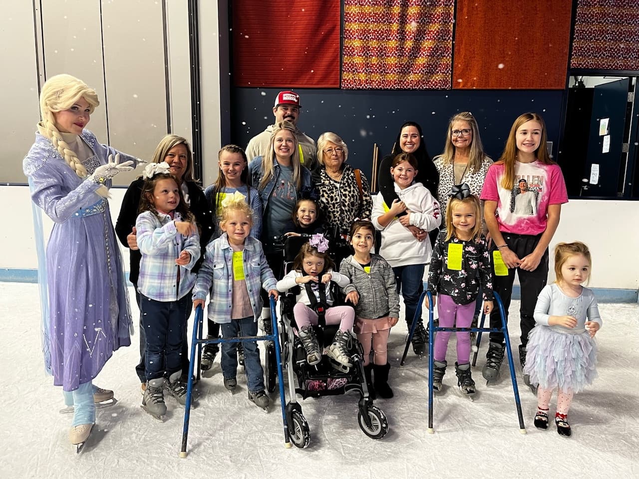 Children and families posing with ice performer at rink