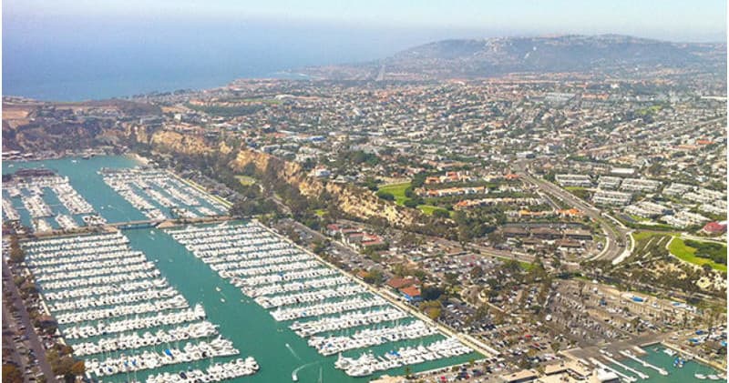 Marina aerial view with thousands of boats and coastal skyline