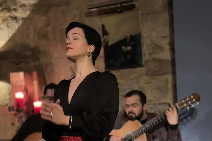 Female singer performing flamenco in intimate indoor guitar venue