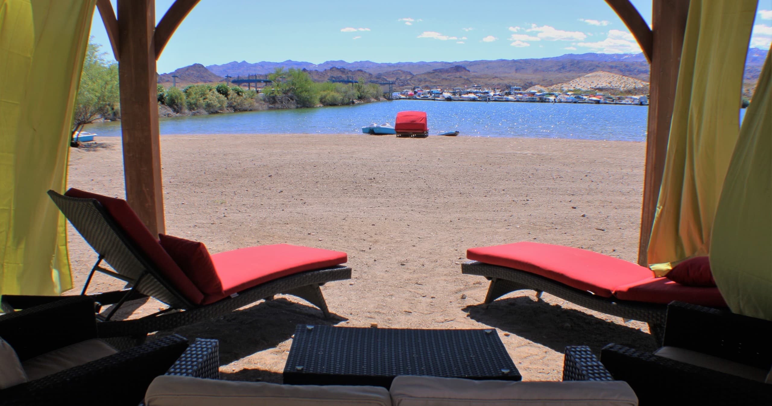 Lakeside cabanas and lounge chairs on sandy Lake Mohave beach