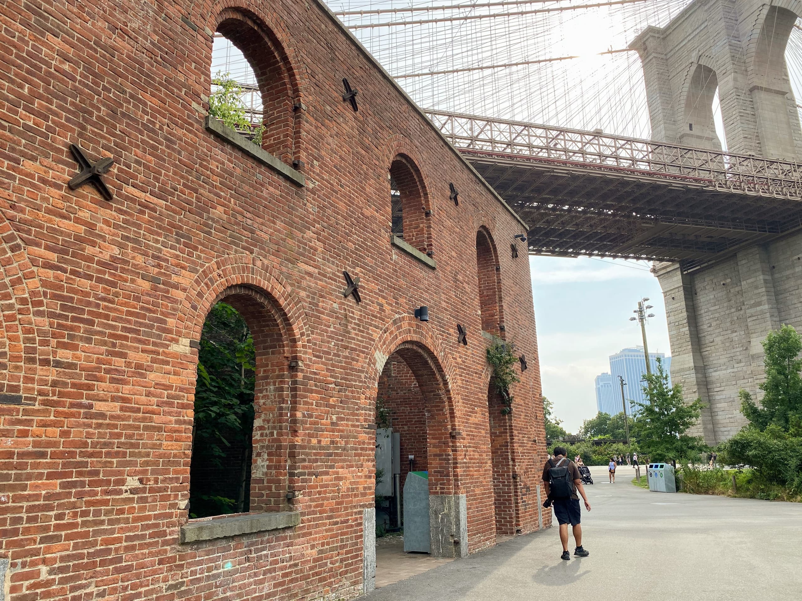Historic brick piers and arches under Brooklyn Bridge waterfront walk