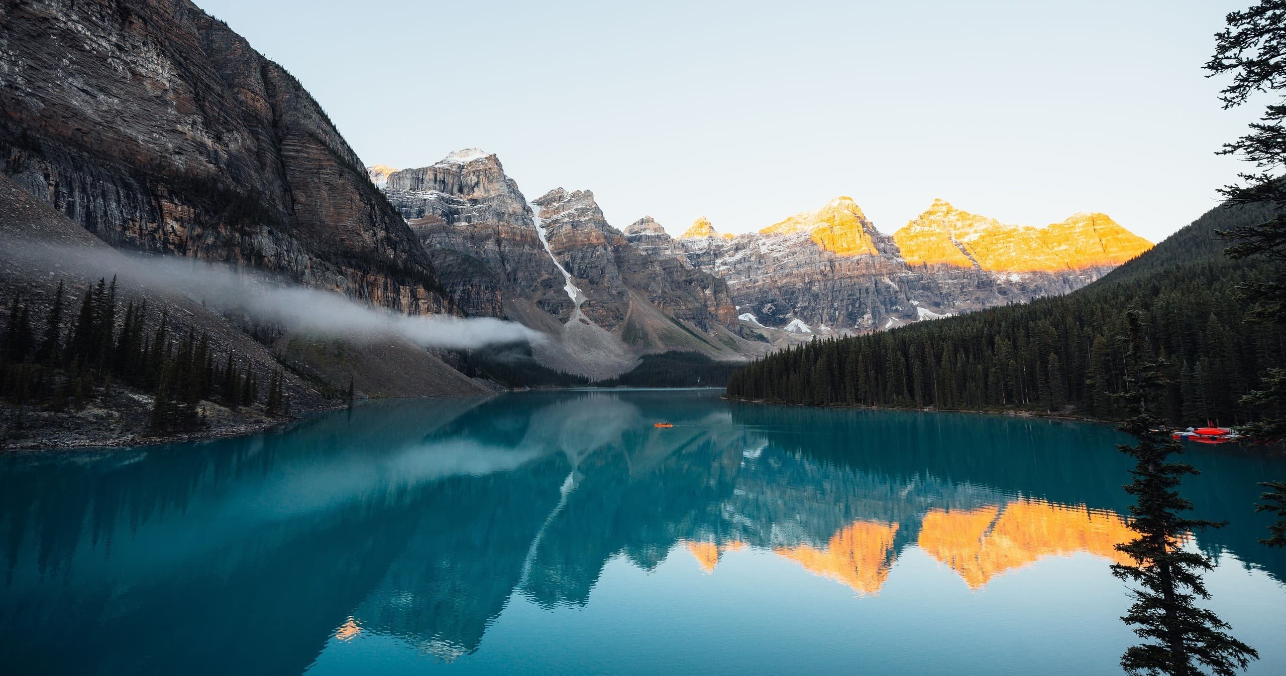 Panoramic mountain lake at dusk with dramatic colorful sky