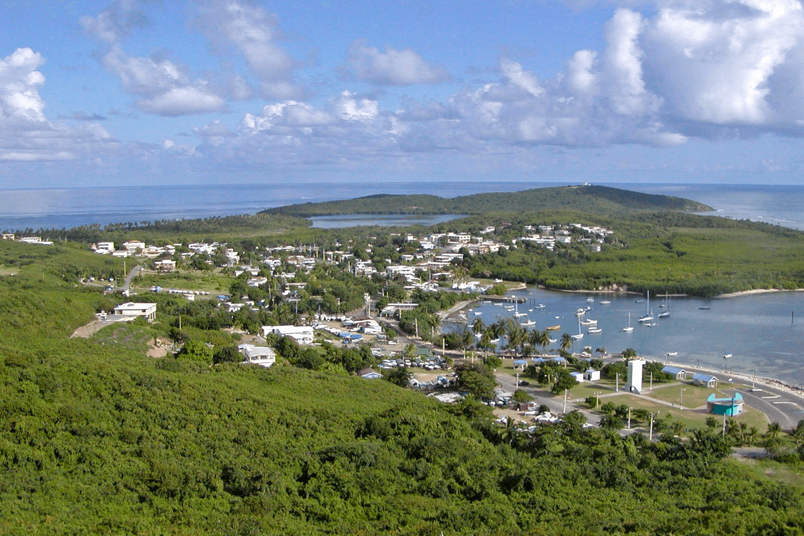 Panoramic coastal town and marina on tropical island bay