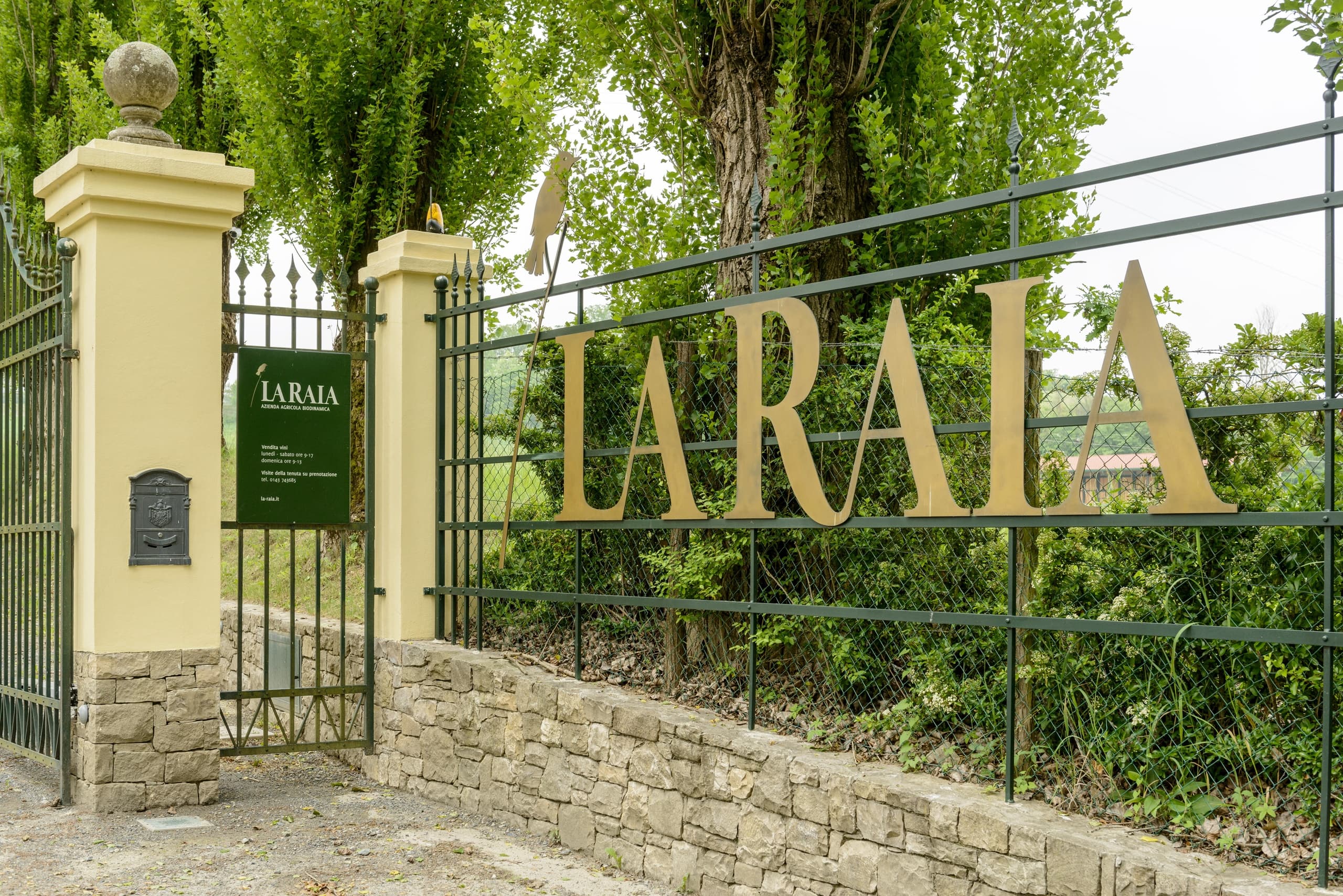 Ornate vineyard entrance gate with LARAIA signage at estate