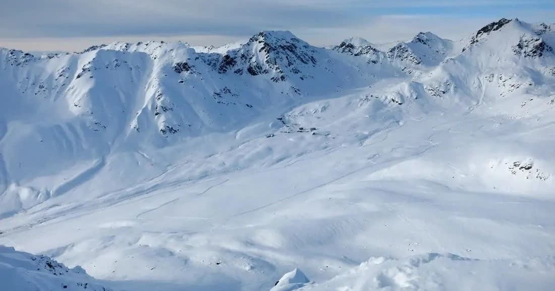 Wide snow-covered alpine slopes ideal for backcountry skiing in Alaska