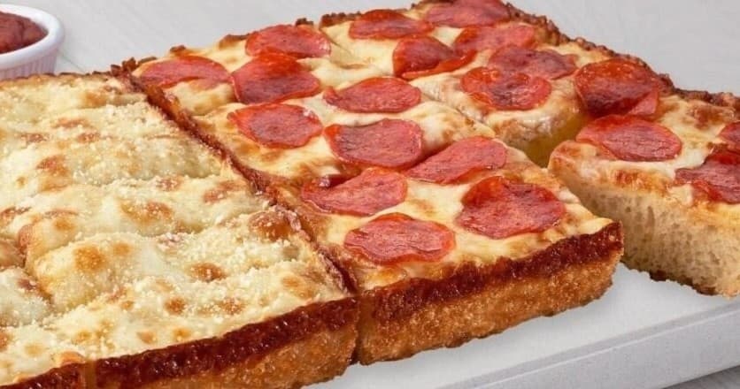 Pepperoni deep-dish pizza close-up on indoor restaurant tray