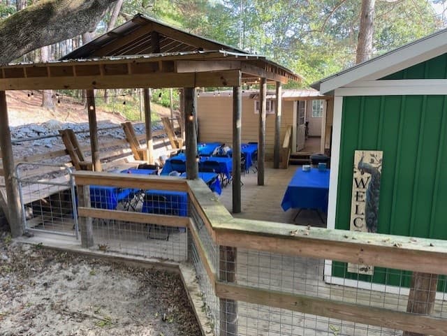 Outdoor sanctuary pavilion and visitor area with wooded backdrop