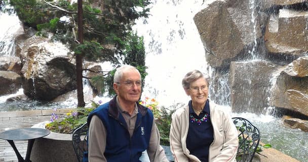 Couple seated by scenic waterfall on Puget Sound garden stroll