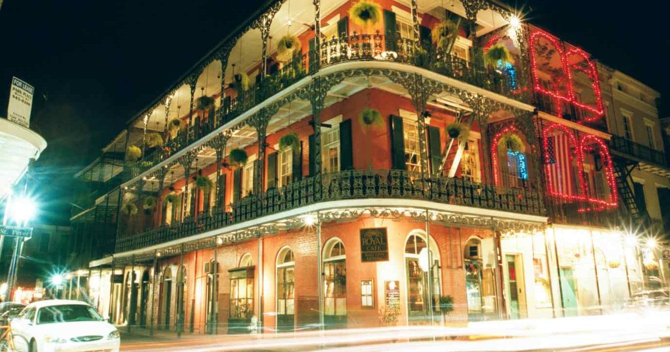 Historic French Quarter balcony lit at night in New Orleans