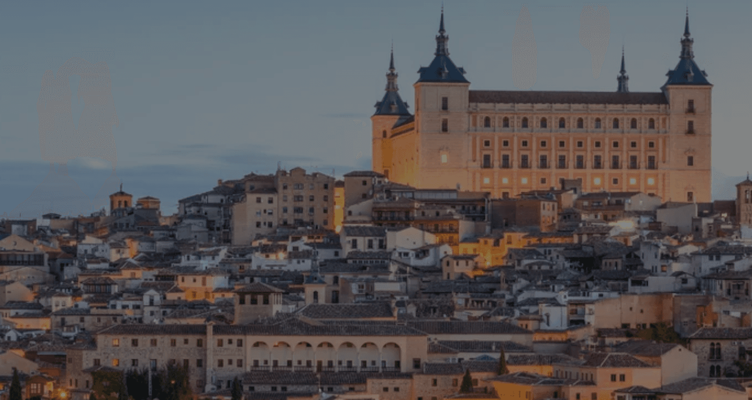 Hilltop Alcázar castle skyline at sunset overlooking Toledo cityscape