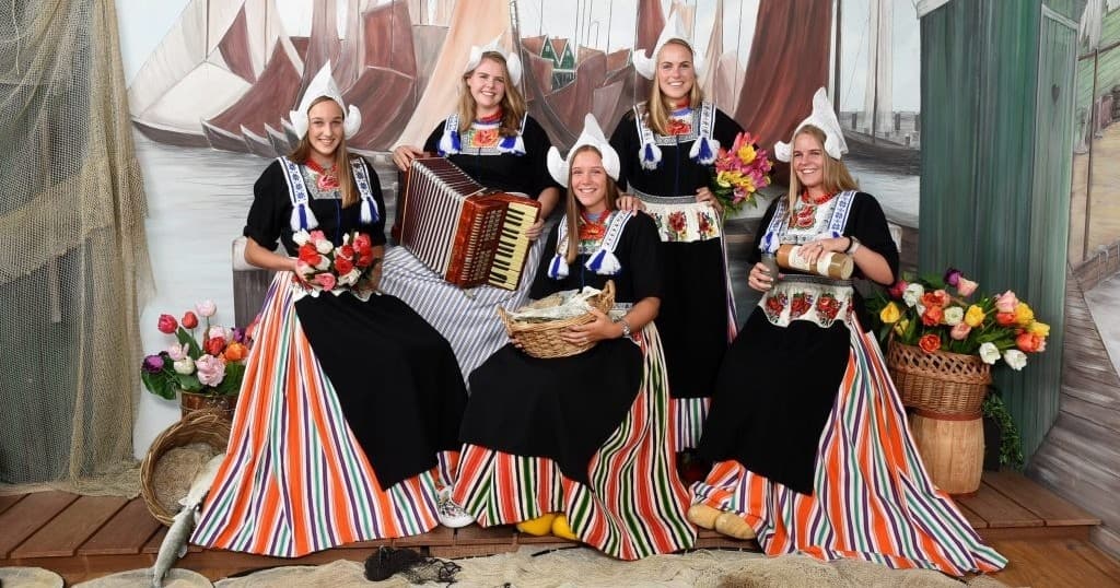 Women in traditional Volendam costumes performing with accordion