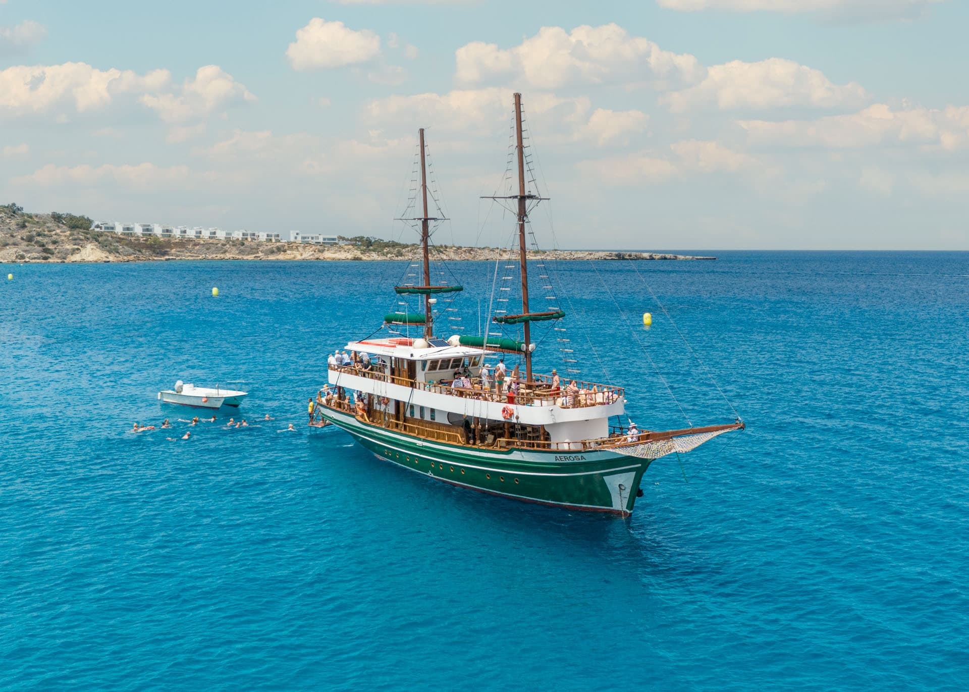 Wooden cruise boat sailing turquoise Mediterranean near Larnaca coast