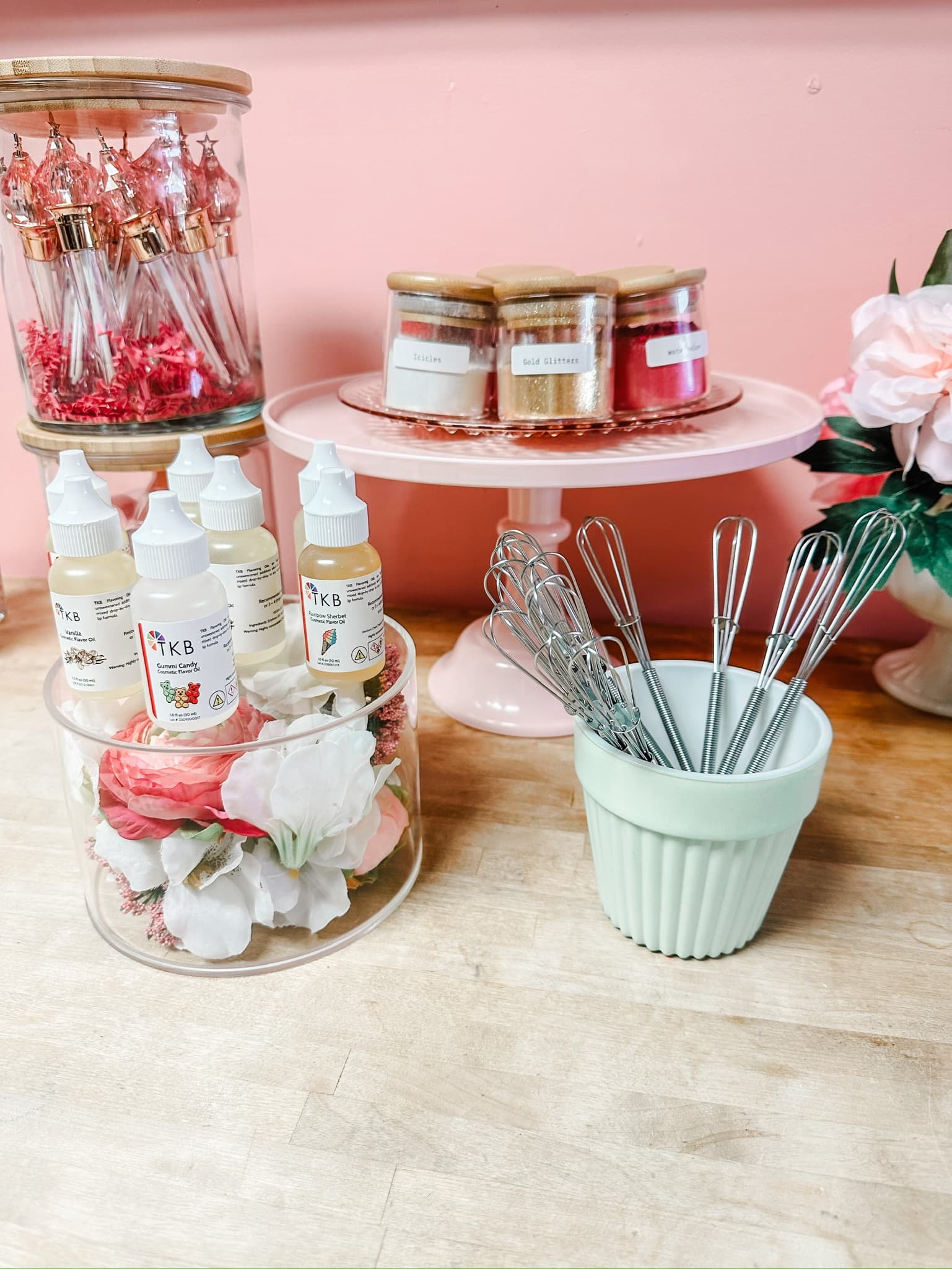Handmade soap and supplies displayed on wooden counter in studio