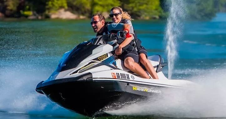 Riders jet skiing across Lake Havasu with spray and speed