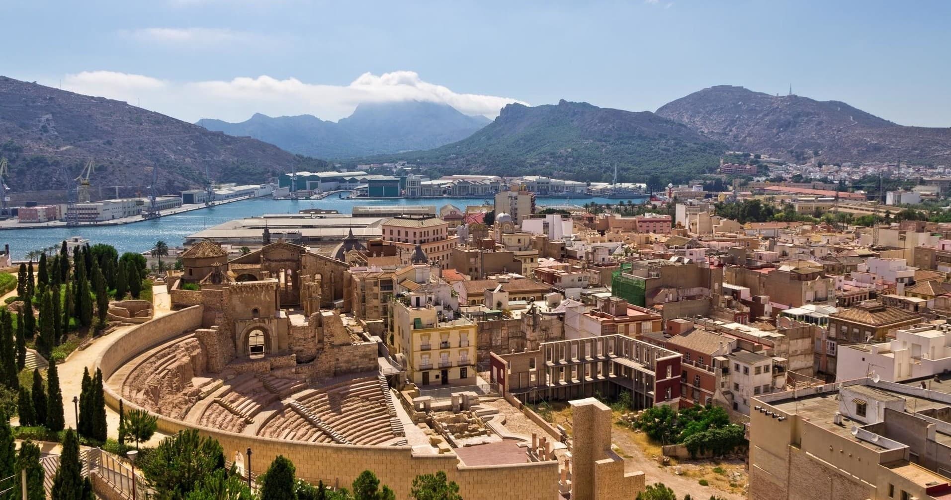 Aerial panoramic of historic coastal town with terracotta rooftops