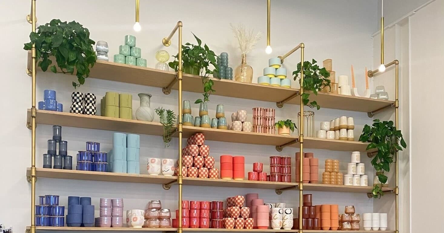 Colorful candles displayed on shelves in Denver candle bar interior