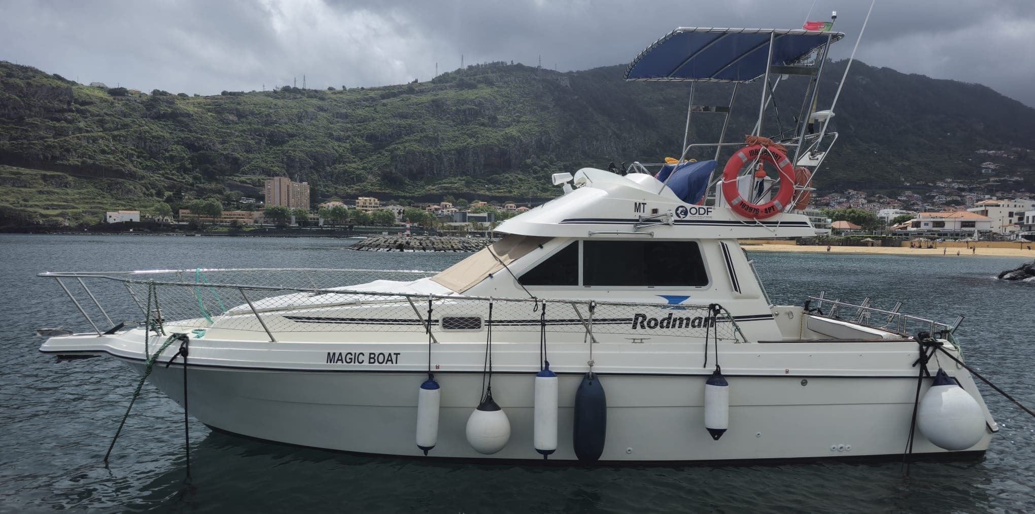 Coastal motorboat moored in harbor, Madeira sea excursion