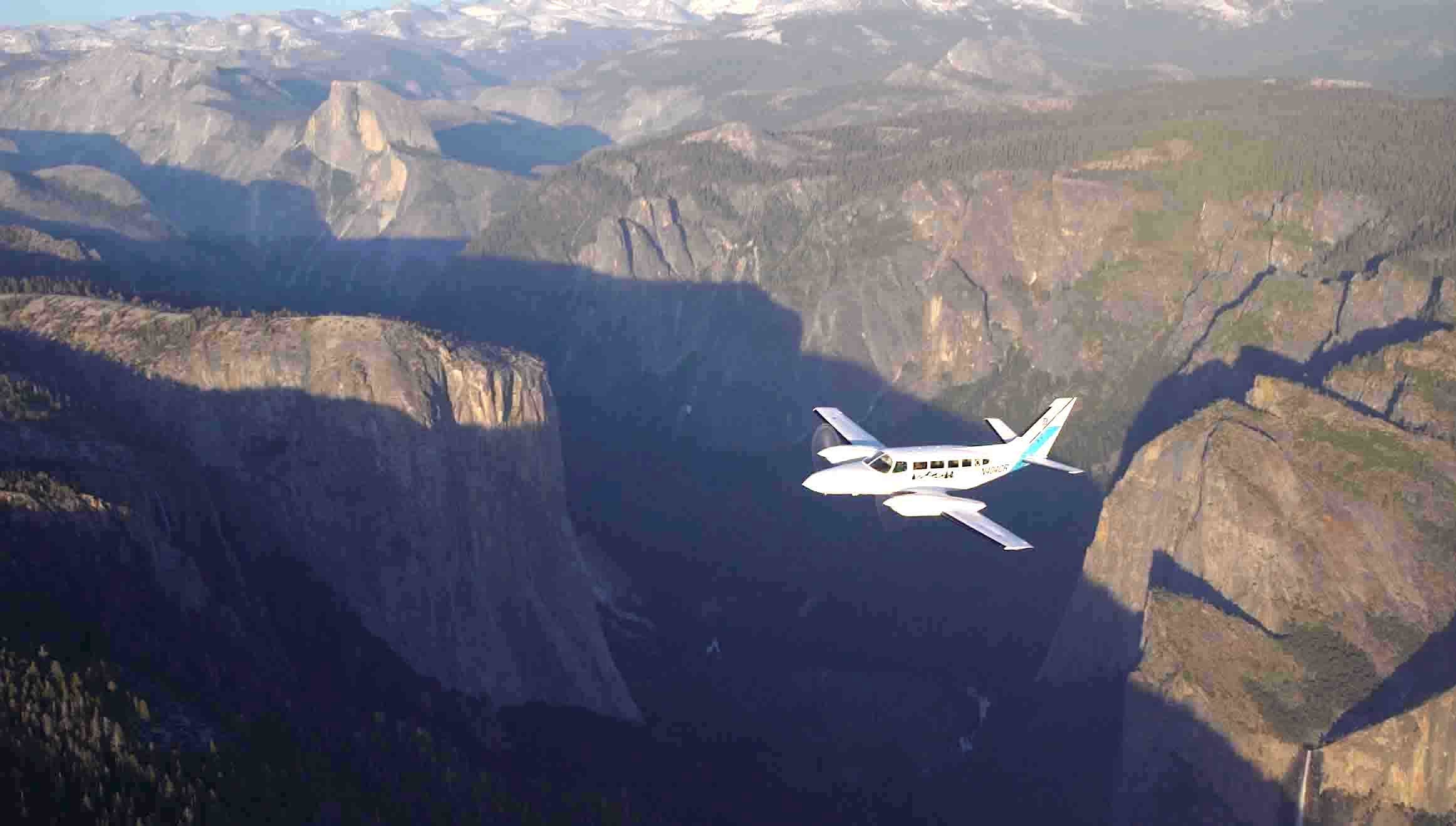 Scenic small plane flying over Yosemite Valley for aerial sightseeing tour