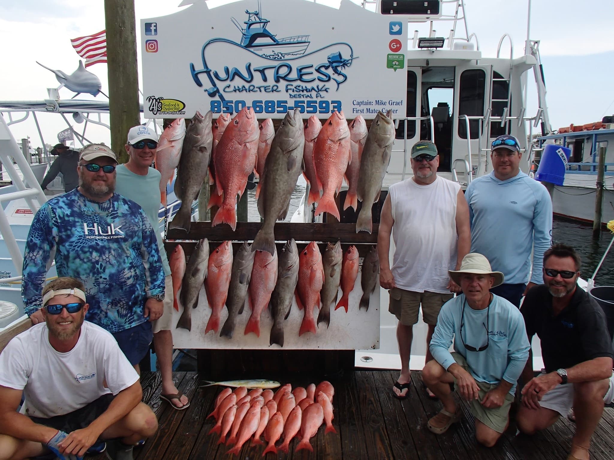 Fishing charter dock photo with red snapper haul and crew